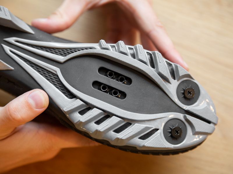 While an MTB shoe has 4 holes for your cleats, you only use the 2 in front or the 2 behind them.